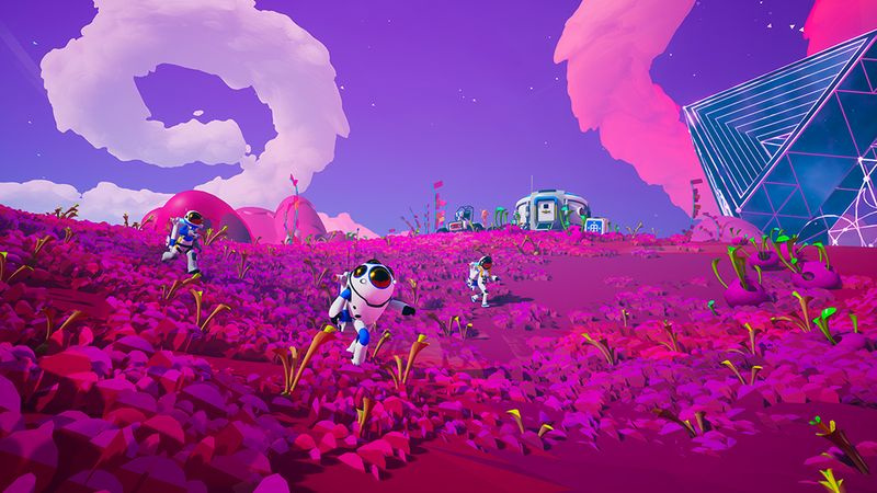 Rymdfolk går över en rosa planet i Astroneer
