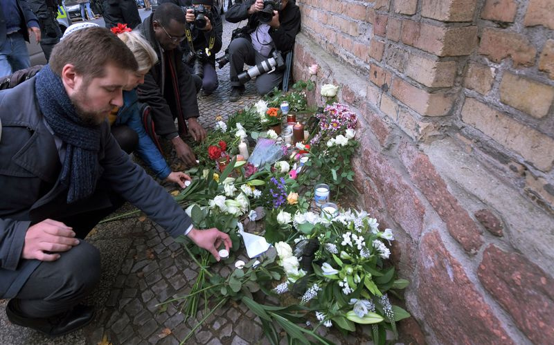 Trauernde legen Blumen am Ort des Anschlags auf die Synagoge von Halle nieder