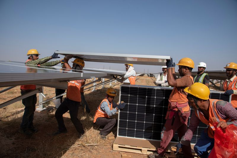 Foto einer Gruppe von Männern, die neue Solarmodule installieren